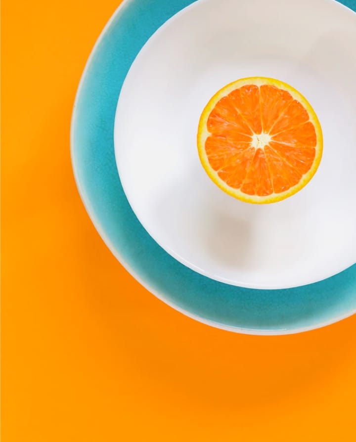 half orange in a white plate